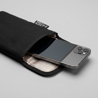 Smartphone sliding into a black Faraday phone bag